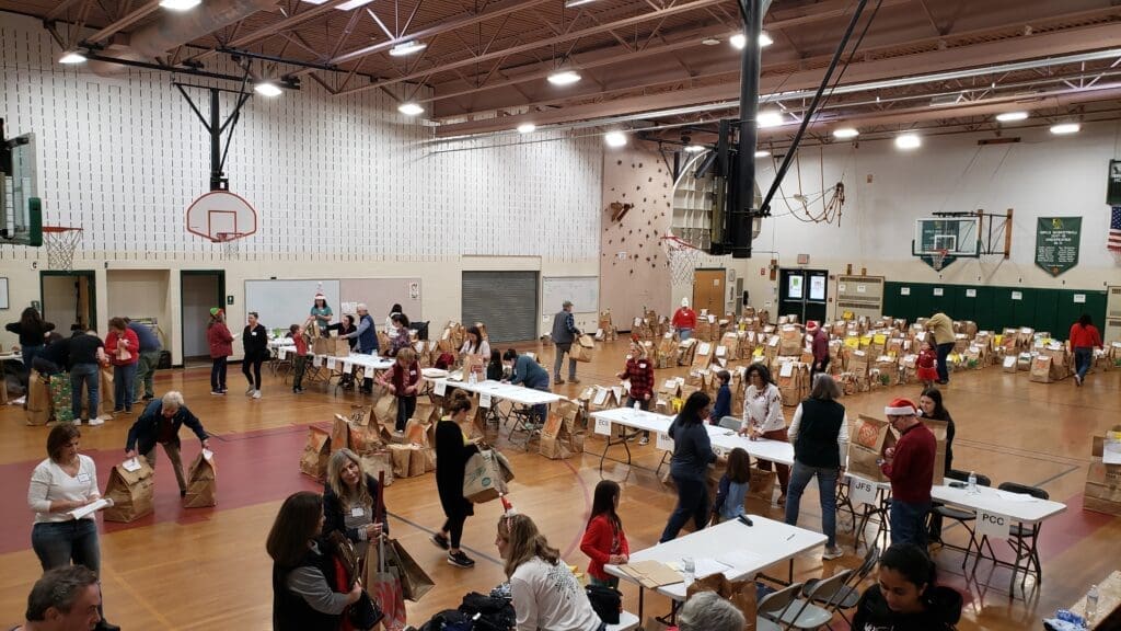 Gym filling up with people and bags of gifts